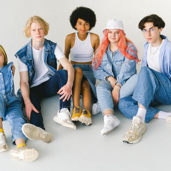 Group of diverse people smiling and moving together in a bright studio.
